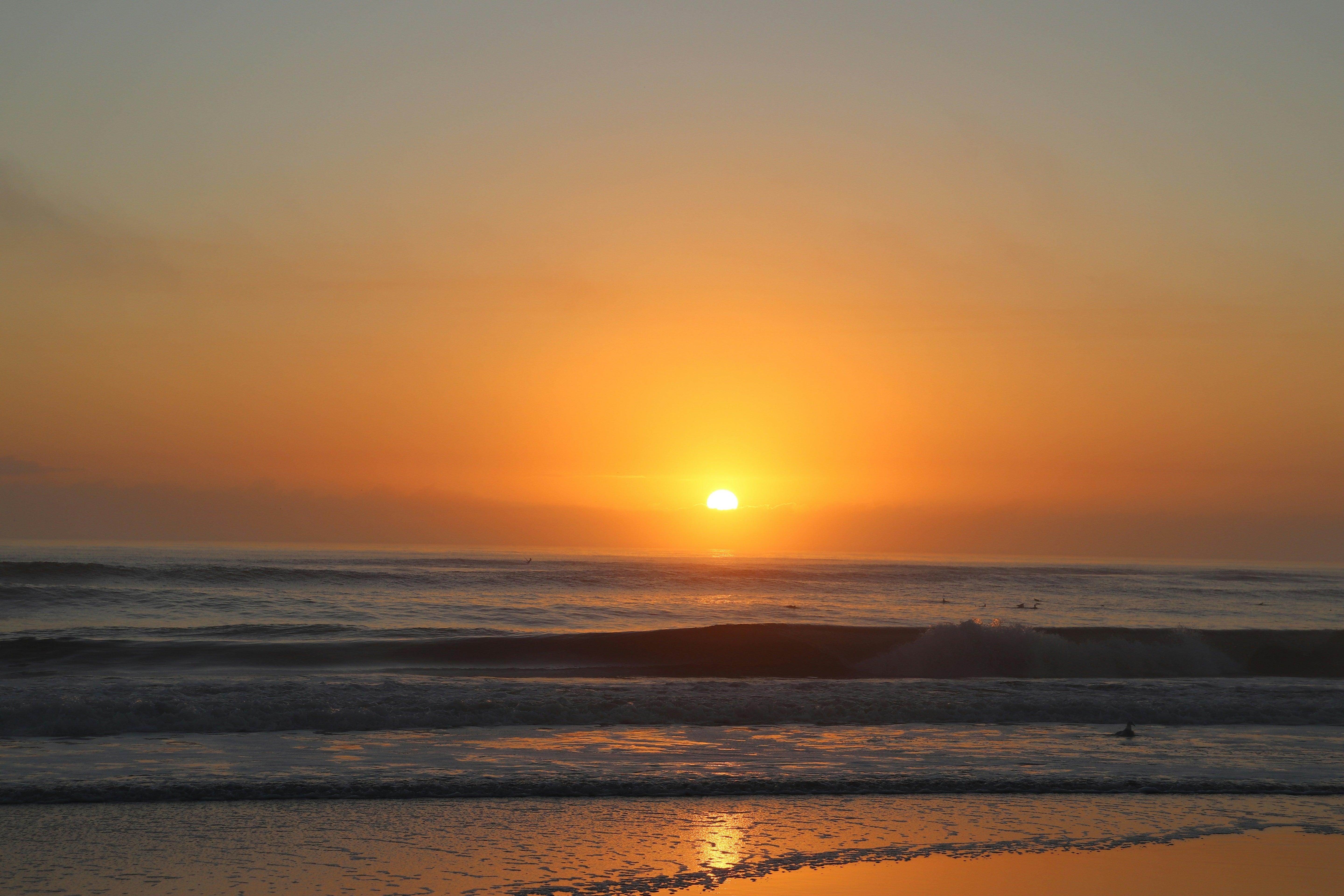 sunset at the beach with waves