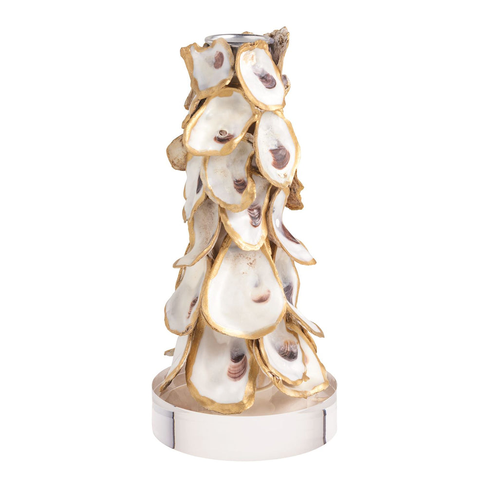 A tall tapered candle holder covered in overlapping oyster shells with gold-edged trim, mounted on a polished silver-tone cylindrical base with a metal candle socket at the top.