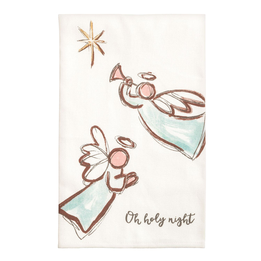 Two cream kitchen towels side by side: the left shows a watercolor nativity stable with a manger, two sheep wearing wreaths, evergreen garland, and the words 'Away in a manger'; the right shows a Holy Family scene with a standing figure, kneeling figure, infant, flanking evergreen trees, a gold star, and the words 'Peace on earth'.