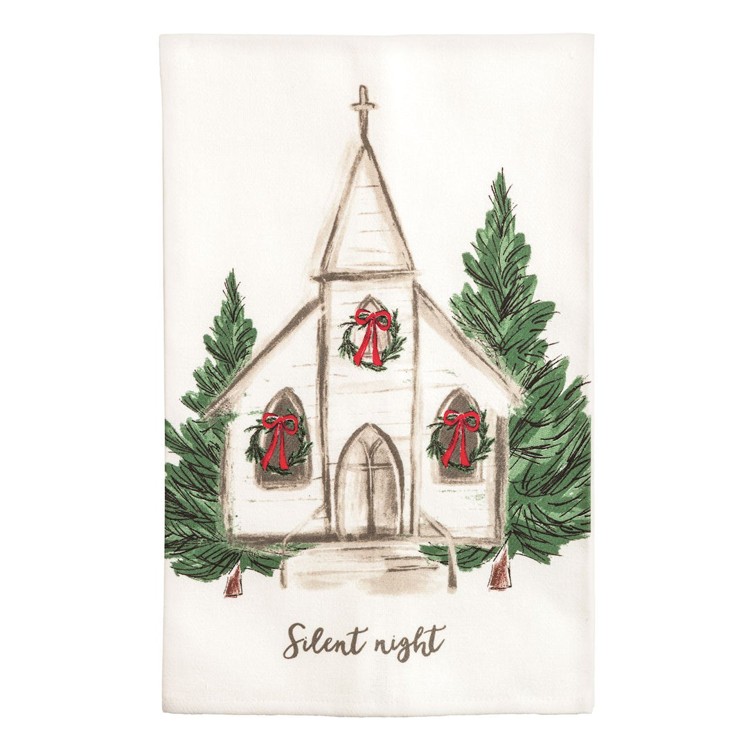 Two cream kitchen towels side by side: the left shows a watercolor nativity stable with a manger, two sheep wearing wreaths, evergreen garland, and the words &