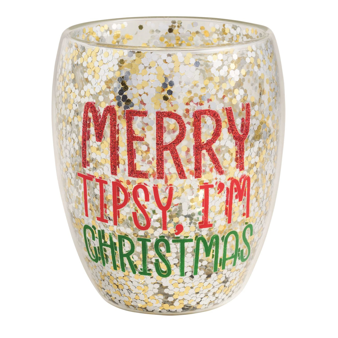 A double-walled stemless wine glass filled with gold and silver confetti glitter, printed with the words "Merry Tipsy, I&