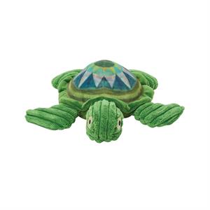 A green plush sea turtle stuffed animal with a ribbed corduroy-textured body and a structured dome shell featuring a geometric diamond pattern in teal, blue, and green.