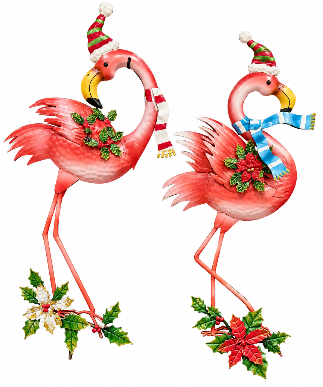 Two coral pink metal flamingo holiday garden stakes, each wearing a striped Santa hat and scarf — one with a red-and-white scarf, one with a blue-and-white scarf — with sculpted holly and red berry clusters at the chest and base.