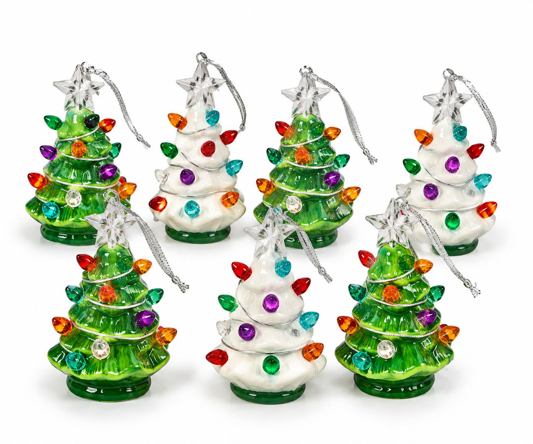 Seven miniature ceramic Christmas tree ornaments in green and white glazed finishes, each decorated with multicolor jewel-toned bulb accents and topped with a faceted star on a silver cord.