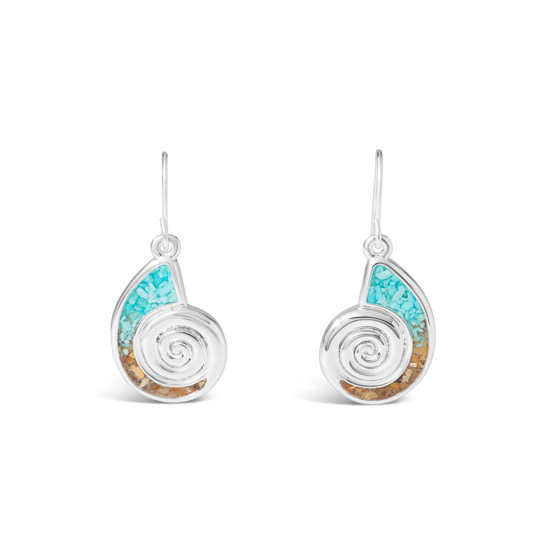 A pair of silver nautilus shell drop earrings with turquoise chip inlay in the upper segment and warm natural sand inlay along the lower spiral border, hanging from French wire hooks.